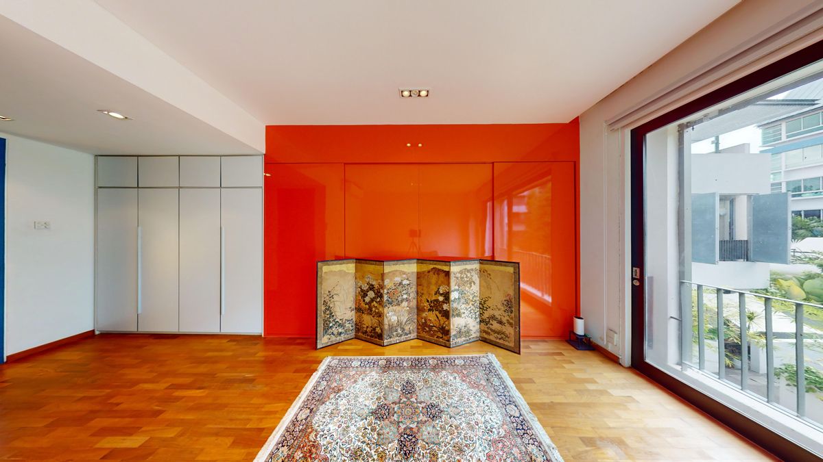 In the junior bedroom, an intricately painted Japanese silk screen stands in contrast to striking Moroccan Red cabinetry