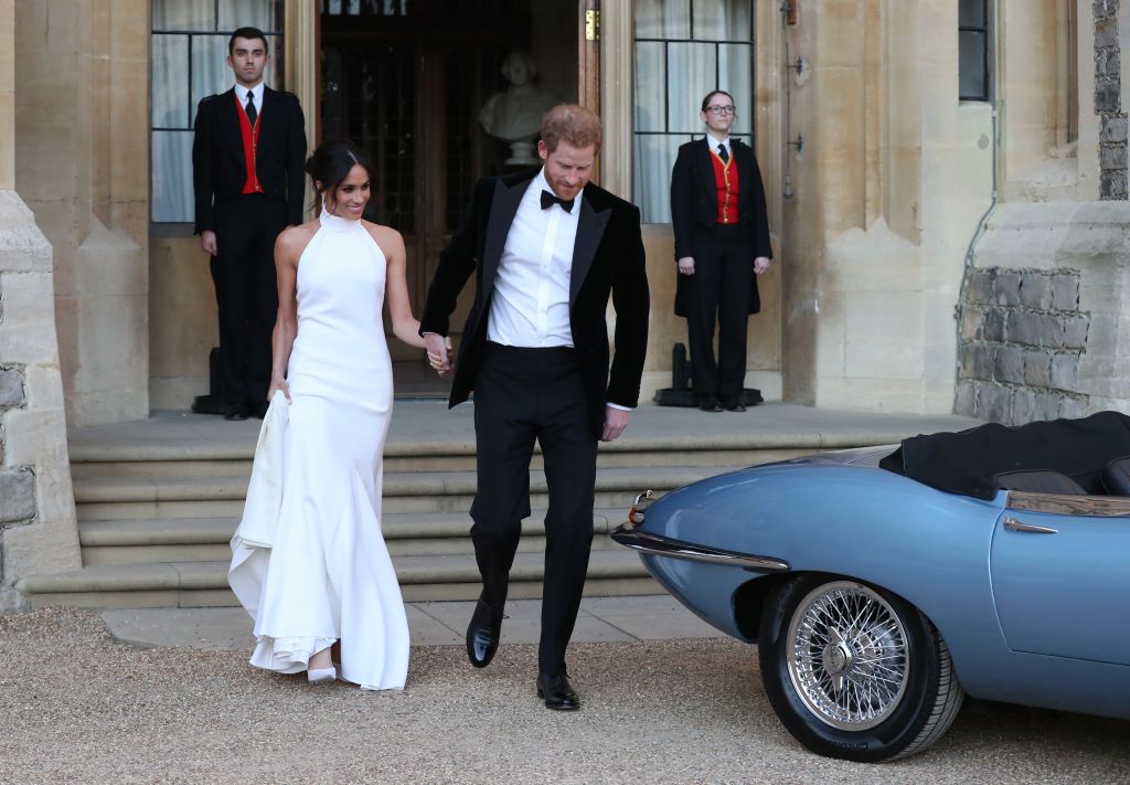 WINDSOR, UNITED KINGDOM - MAY 19: Duchess of Sussex and Prince Harry, Duke of Sussex leave Windsor Castle after their wedding to attend an evening reception at Frogmore House, hosted by the Prince of Wales on May 19, 2018 in Windsor, England. (Photo by Steve Parsons - WPA Pool/Getty Images)