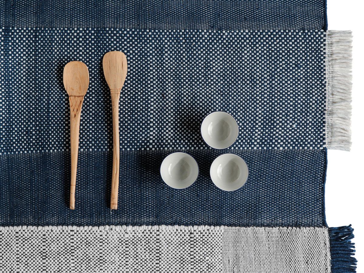 A table mat belonging to the Tres range, comprising Indian dhurrie flat-weave rugs