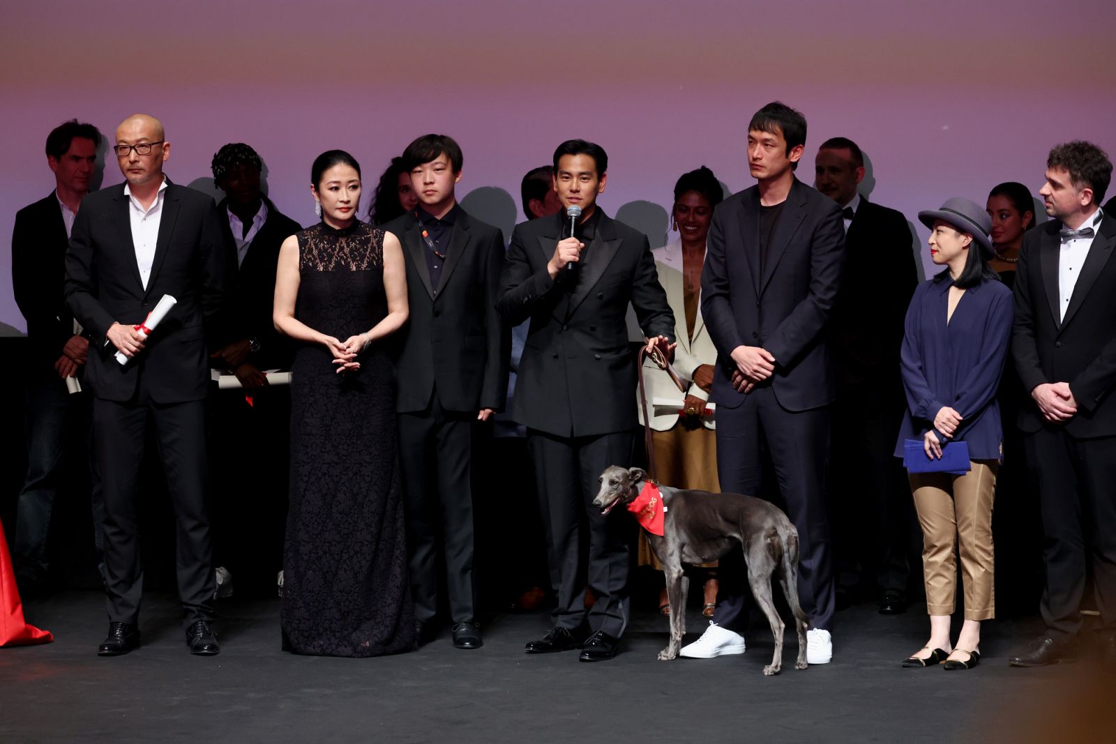 CANNES, FRANCE - MAY 24: Guan Hu, Liang Jing, and Eddie Li accept the Un Certain Regard Prize for "Black Dog" onstage during the Un Certain Regard closing ceremony at the 77th annual Cannes Film Festival at Palais des Festivals on May 24, 2024 in Cannes, France. (Photo by Cindy Ord/Getty Images)