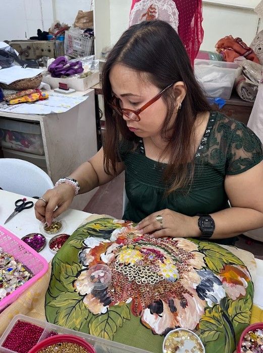 A Laguna local trained by Patis Tesoro in the art of traditional embroidery