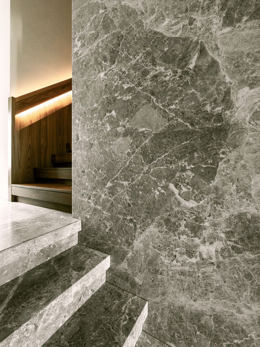 Backlit handrails imbue the stairway with subtle style