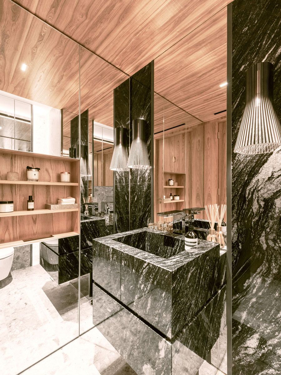 Mirrored walls expand the sense of space in the powder room