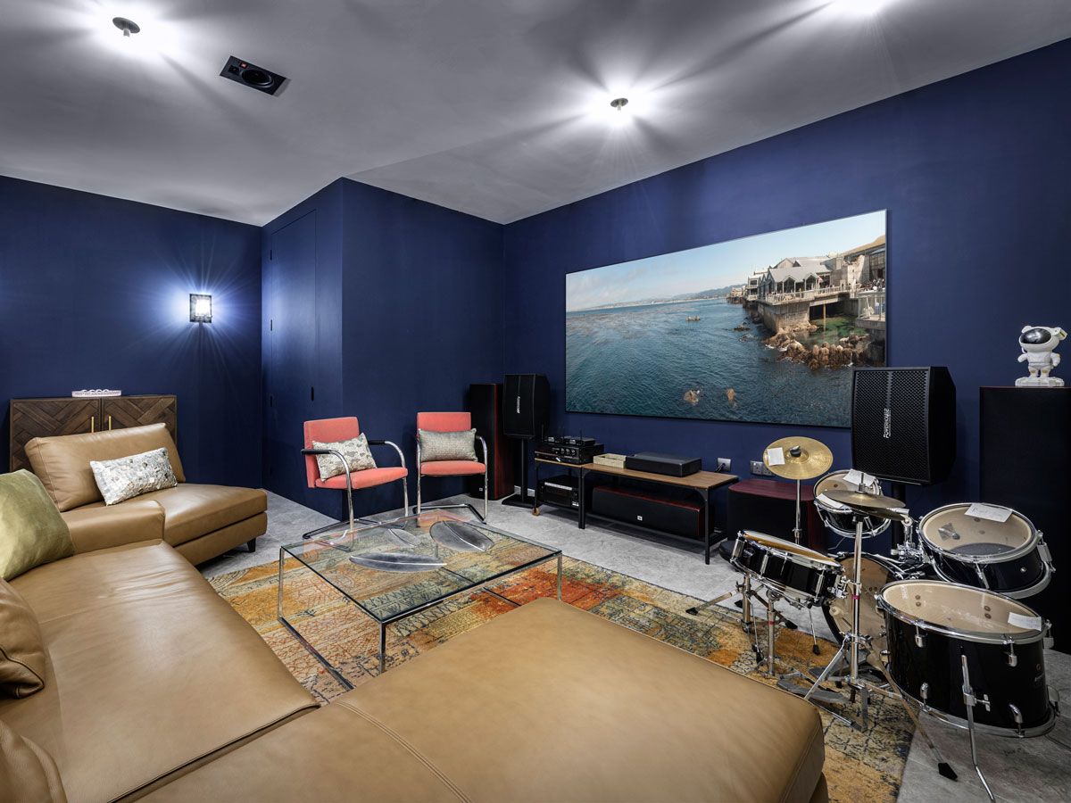 A midnight blue hue sets a relaxing mood in the movie room