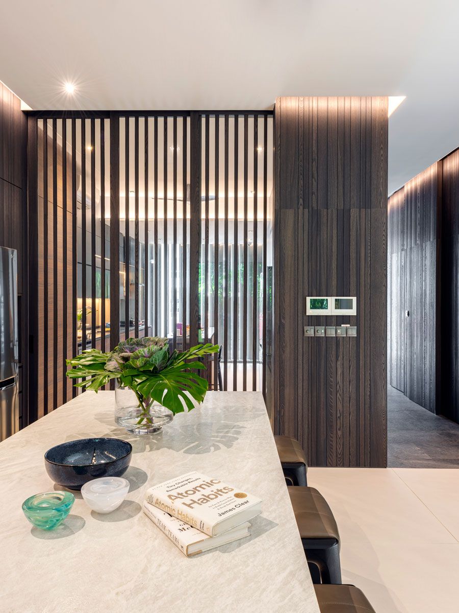 The wet and dry areas of the kitchen are partitioned yet visually connected to each other