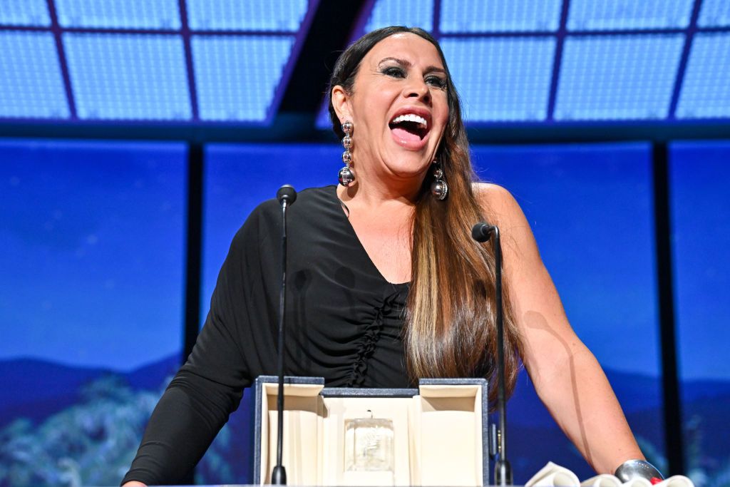 CANNES, FRANCE - MAY 25: Karla Sofía Gascón (L) accepts the 'Best Actress' Award for 'Emilia Perez' alongside Adriana Paz, Selena Gomez and Zoe Saldana during the Closing Ceremony at the 77th annual Cannes Film Festival at Palais des Festivals on May 25, 2024 in Cannes, France. (Photo by Stephane Cardinale - Corbis/Corbis via Getty Images)