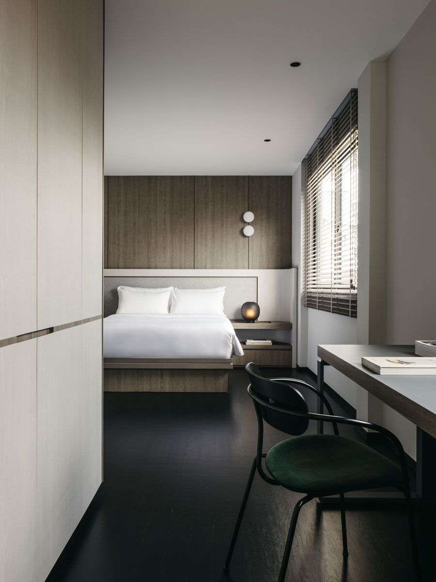 This bedroom continues the home’s serene design language beautifully