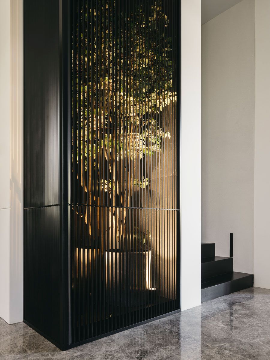 Screened off and illuminated from below, this indoor planter glows with a sense of intrigue