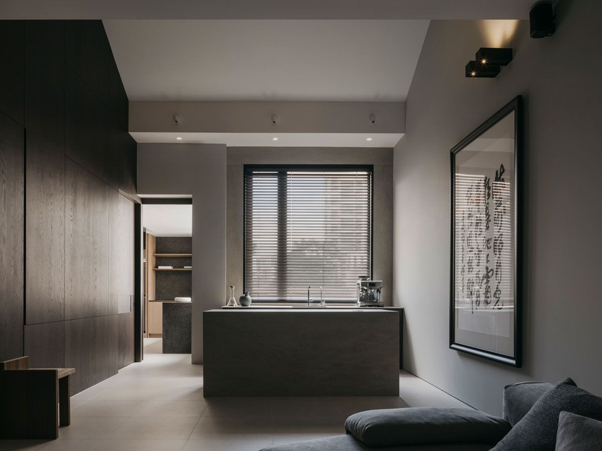 The monolithic form of the island paints a striking composition in the space