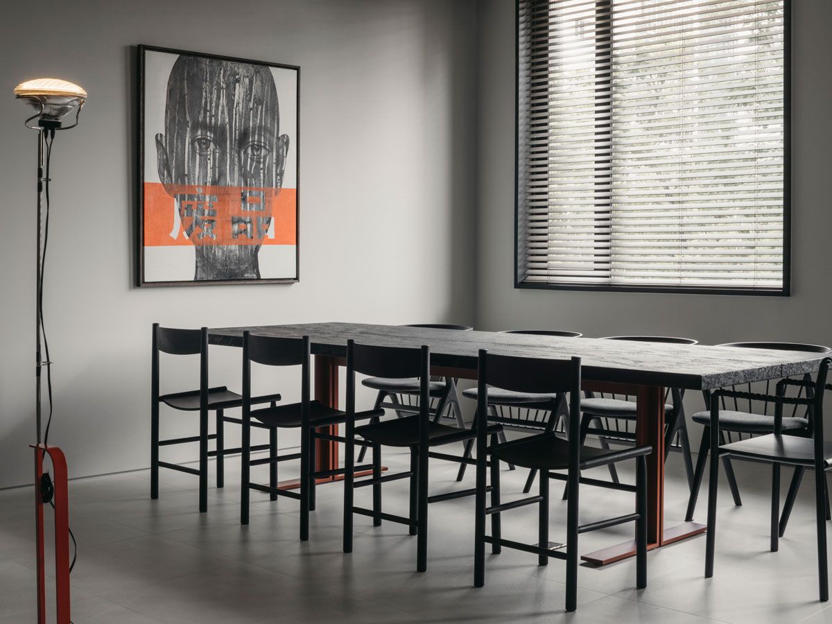 An Artek Rope chair is among the stately black seats in this dining room