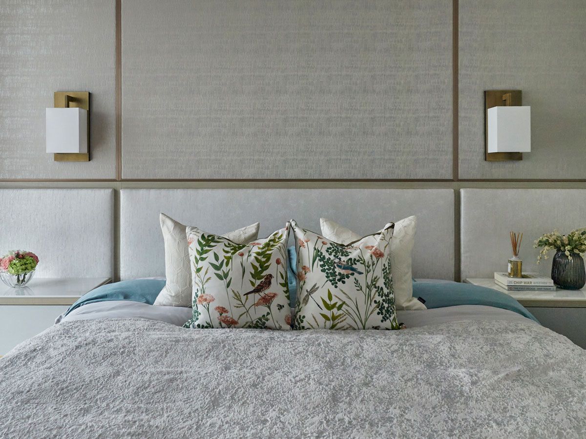 The symmetrical composition of the master bedroom brings to mind the design of hotel suites