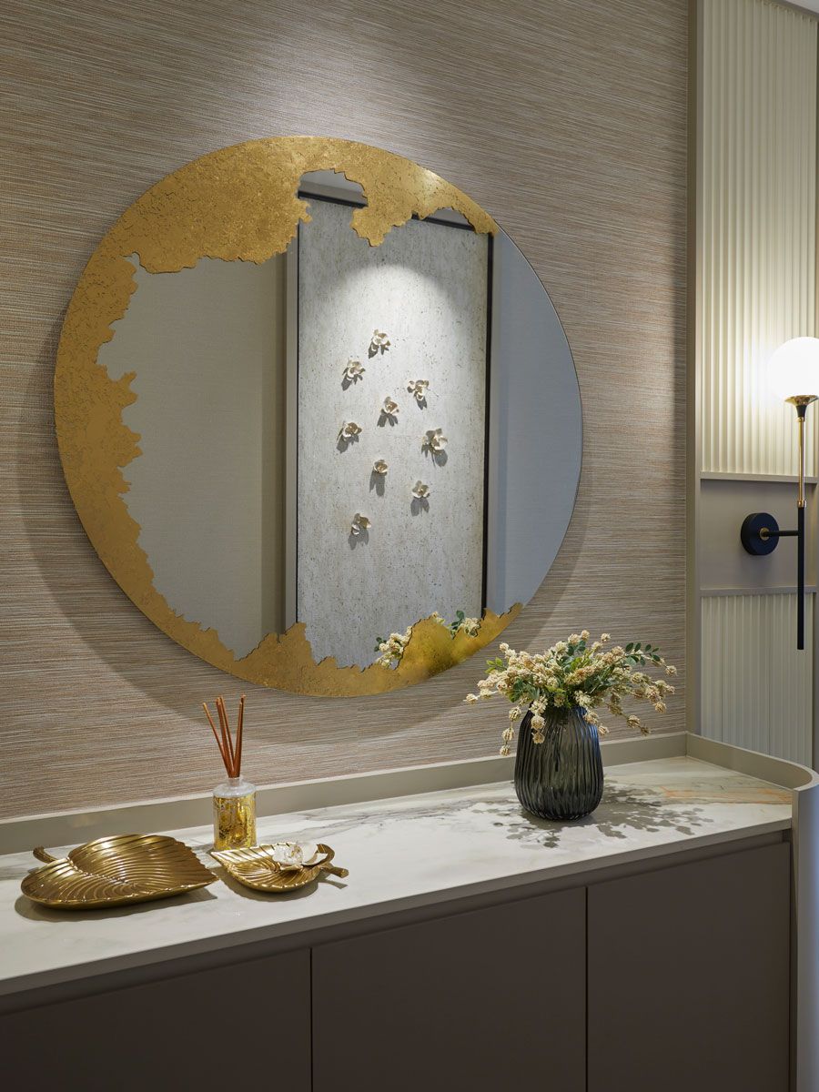 A circular Deknudt Ornato mirror catches the eye in the entryway