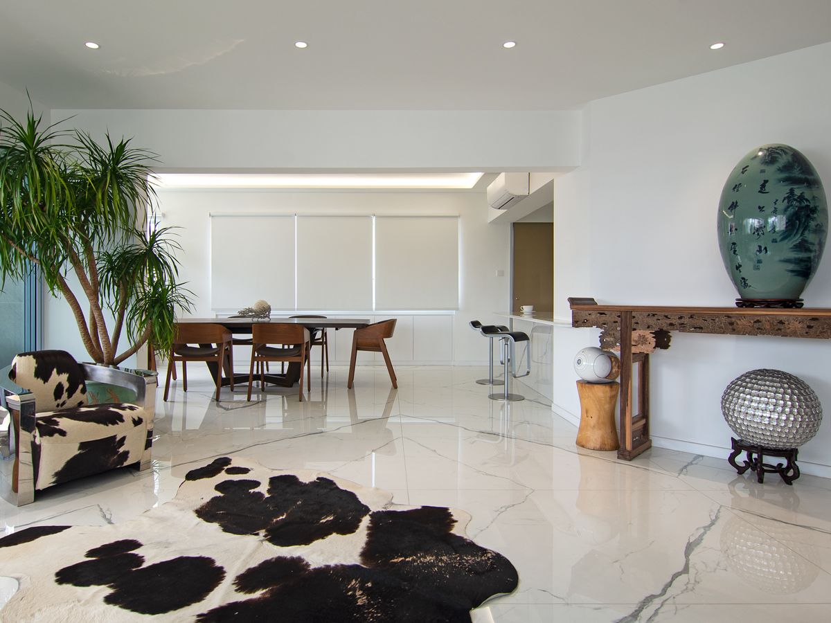 Matching cowhide patterns on the armchair and rug enliven this corner of the living area