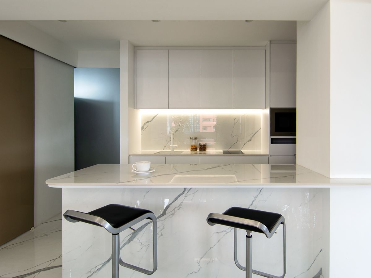 A spacious island and sleek bar stools create a cosy breakfast nook