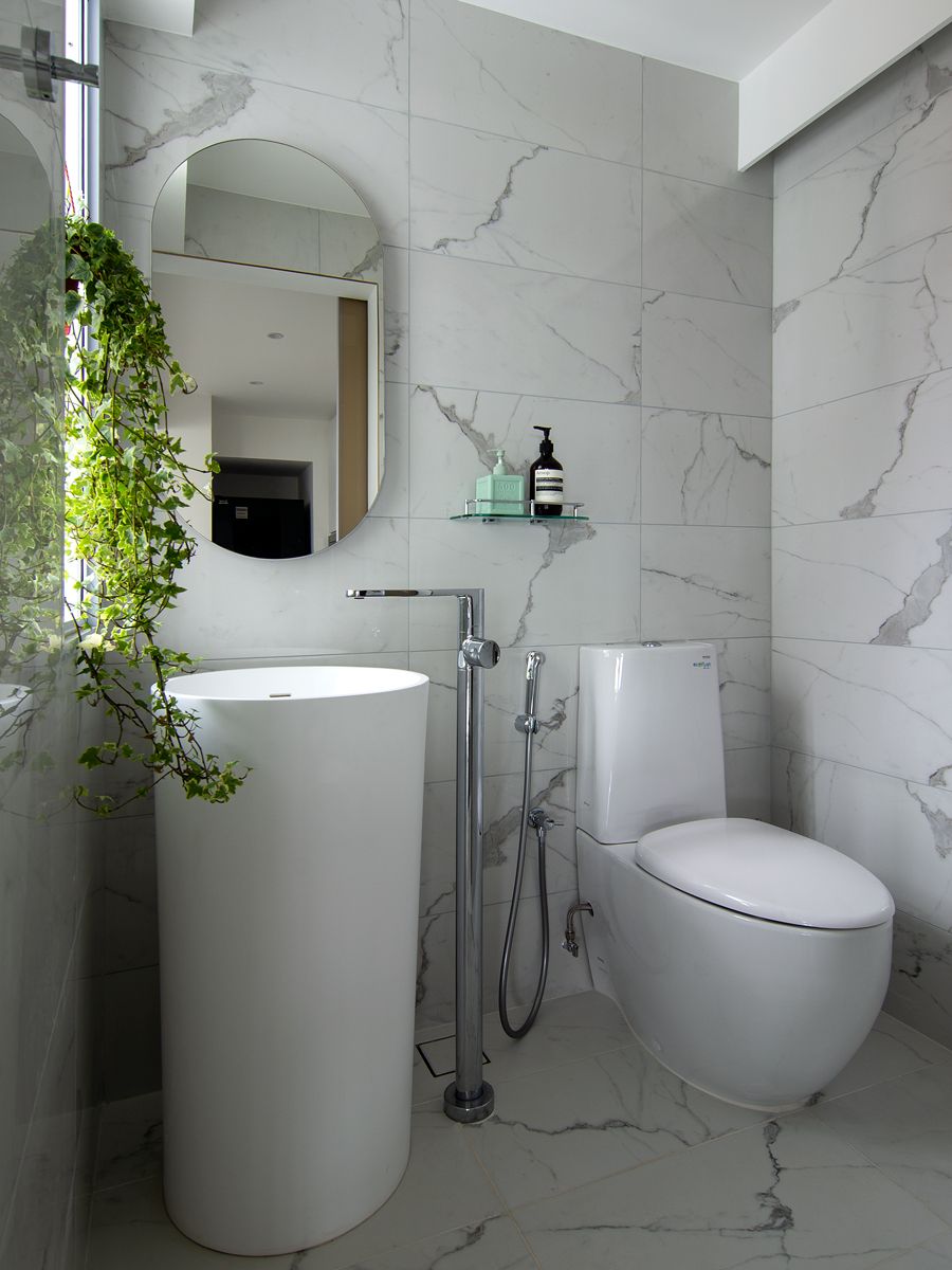 Marble-pattern tiles lend a subtle visual interest in this powder room
