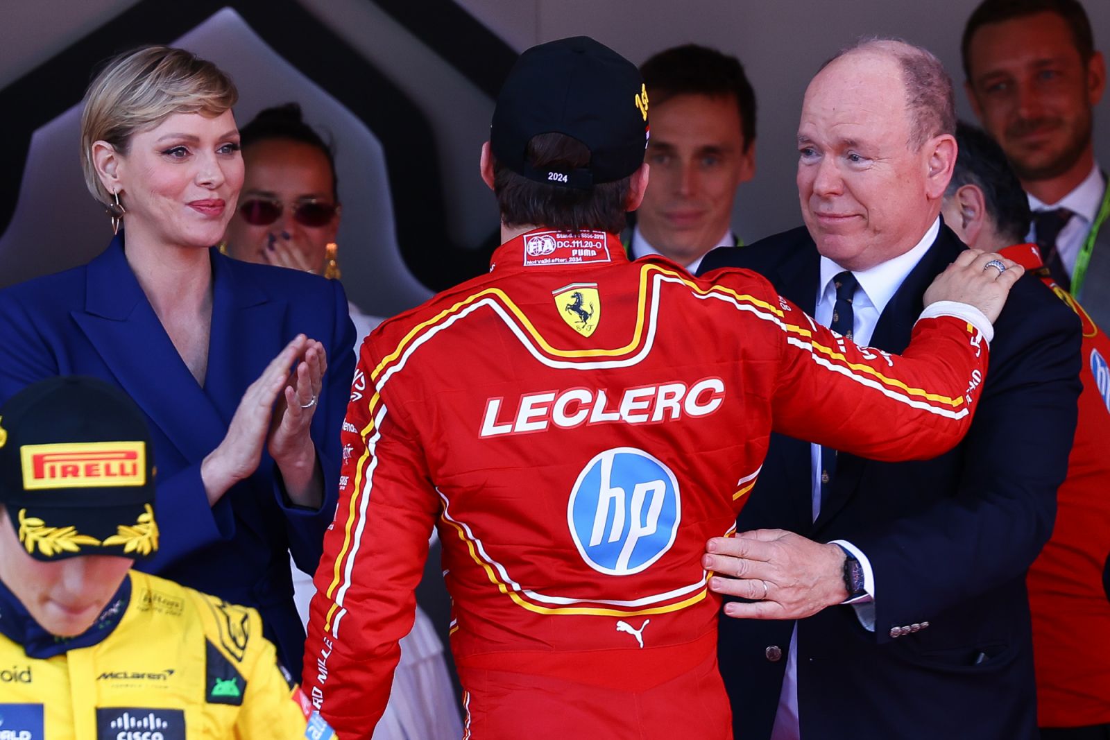 MONTE-CARLO, MONACO - MAY 26: Race winner Charles Leclerc of Monaco and Ferrari celebrates with Prince Albert II of Monaco and Princess Charlene of Monaco on the podium after the F1 Grand Prix of Monaco at Circuit de Monaco on May 26, 2024 in Monte-Carlo, Monaco. (Photo by Marc Piasecki/WireImage)