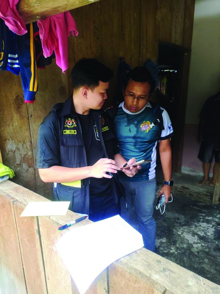 Dr Mohamad Fadli Kharie (right) on the ground in Sabah
