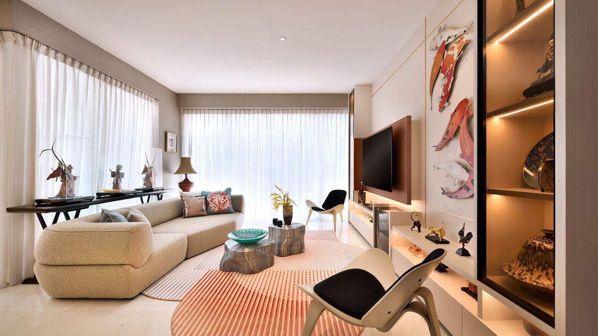 An overview of the living room, in which an artwork featuring a school of koi fish catches the eye, as designed by Prestige Global Designs