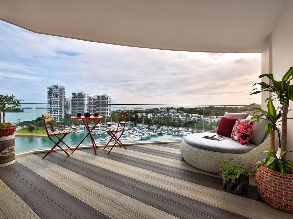 Red accents and a houseplant jazz up the outdoor terrace, which looks out to serene views of the marina