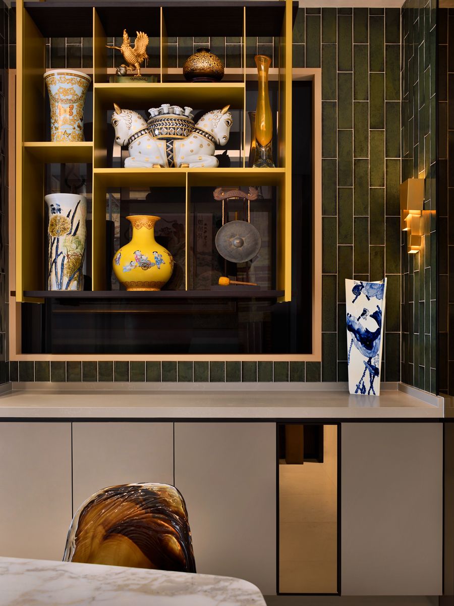Gold shelves showcase the family’s collection of objets d’art
