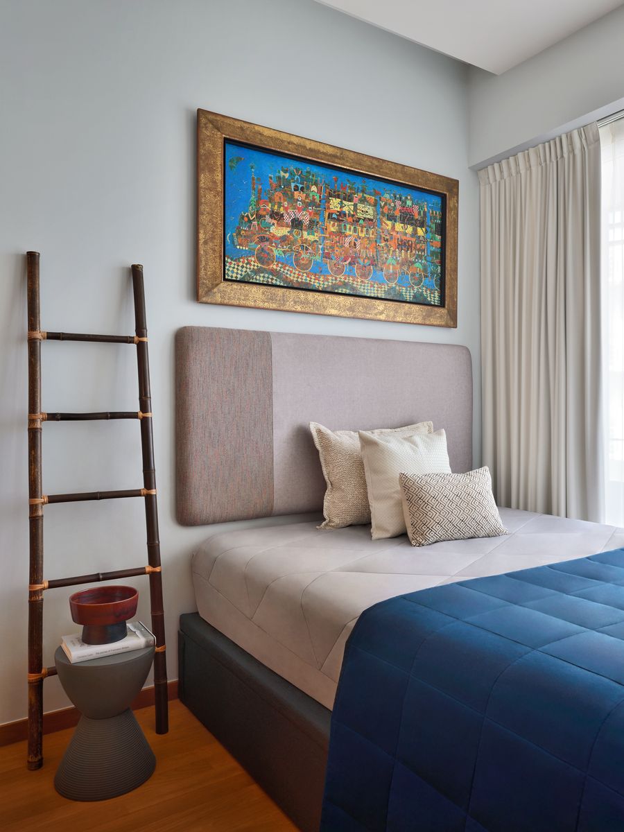 The guest room is designed with soothing blue and earthy tones