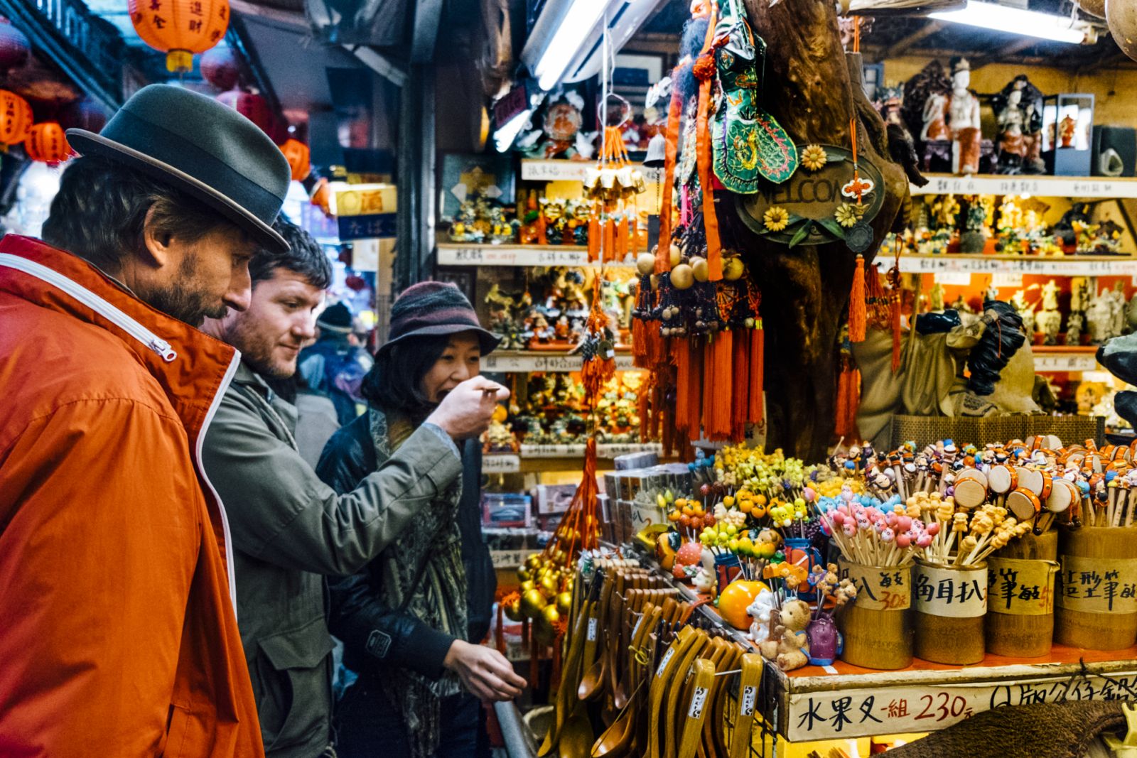 Two Caucasian males and an Asian female in Taiwanese open air Market