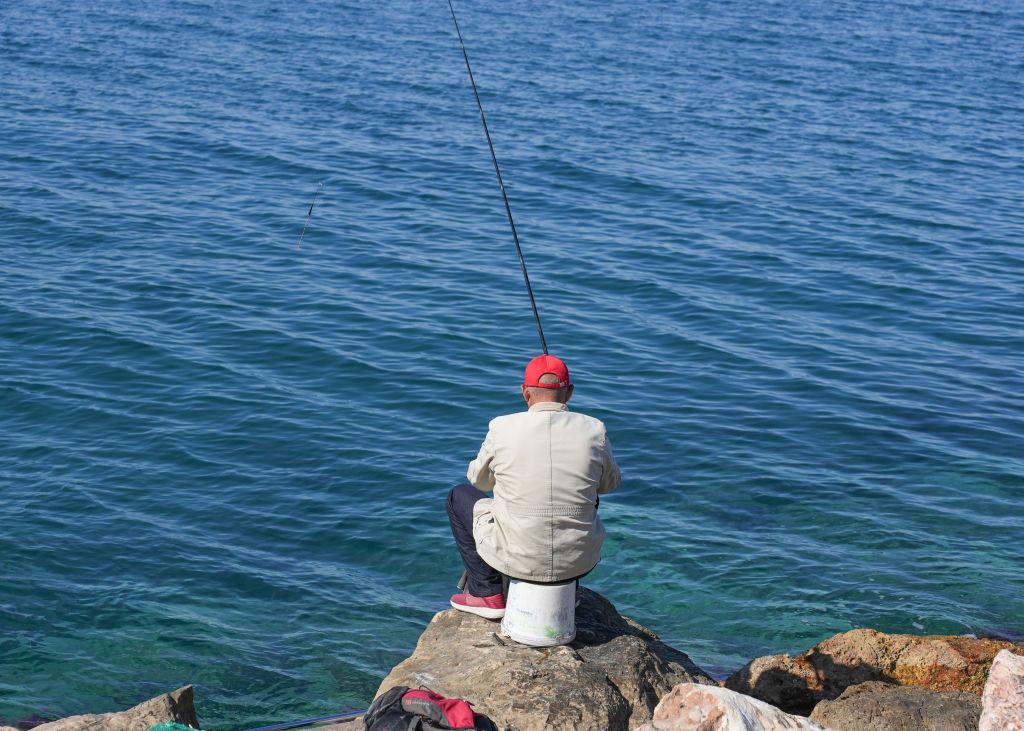 A fisherman is enjoying a sunny day in the suburb of Palaio Faliro in Athens, Greece, on May 12, 2024. (Photo by Giannis Alexopoulos/NurPhoto via Getty Images)