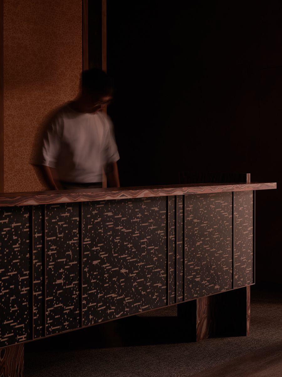 The reception counter continues the mid-century colour palette utilised throughout the show gallery