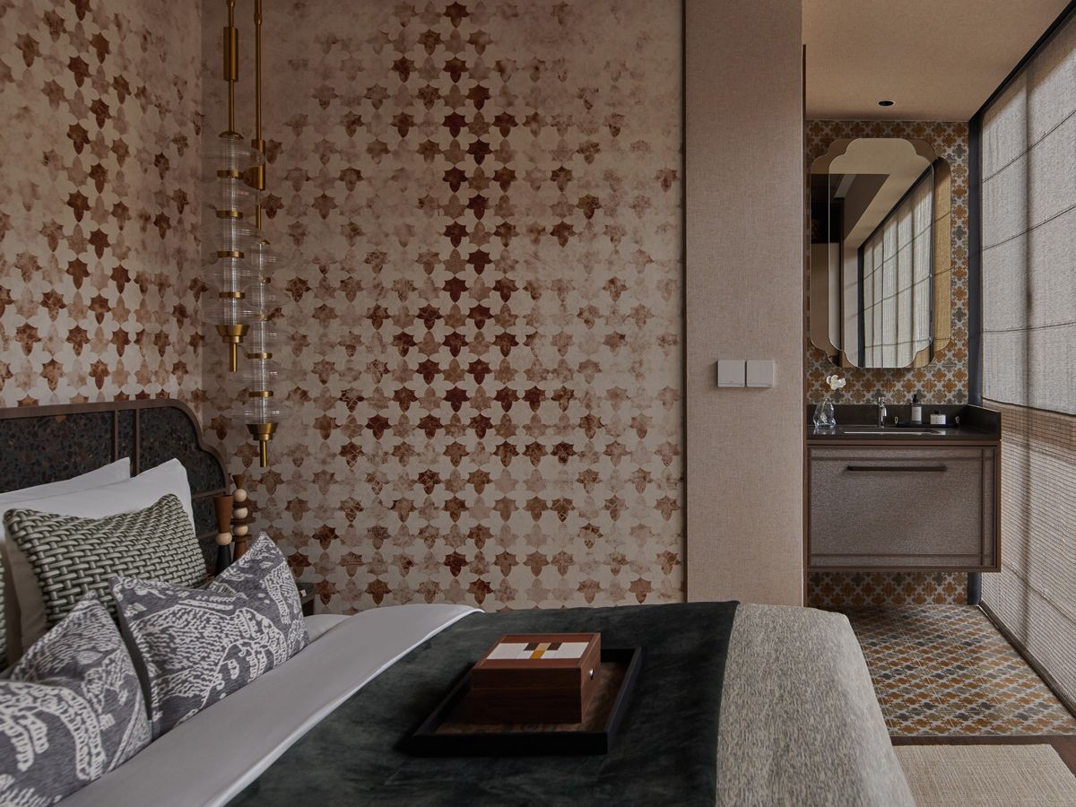 The abstract design on the wallcovering in the master suite offers a nod to the botanical motifs common to Peranakan tiles