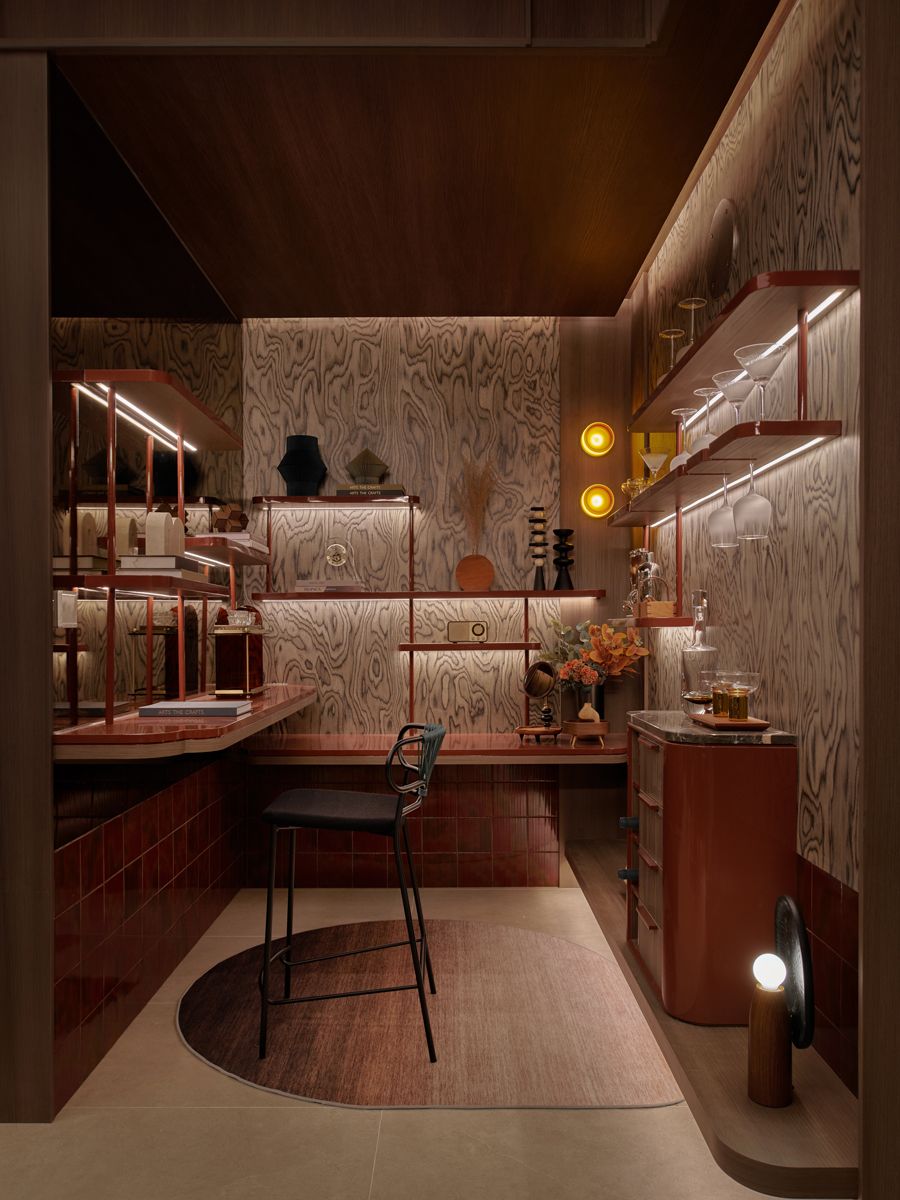 Featuring terracotta hues and shelves to house drinkware, the study is designed as a space made for both focus time and cocktail hour