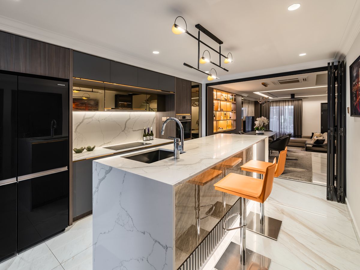 A spacious island with bar stools carves out a social nook in the kitchen