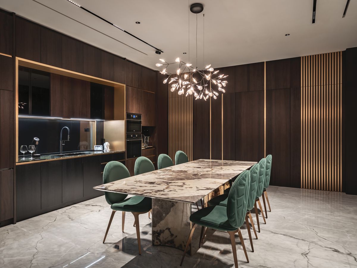Metal-trimmed custom cabinetry and joinery keep this dining area neat and luxurious