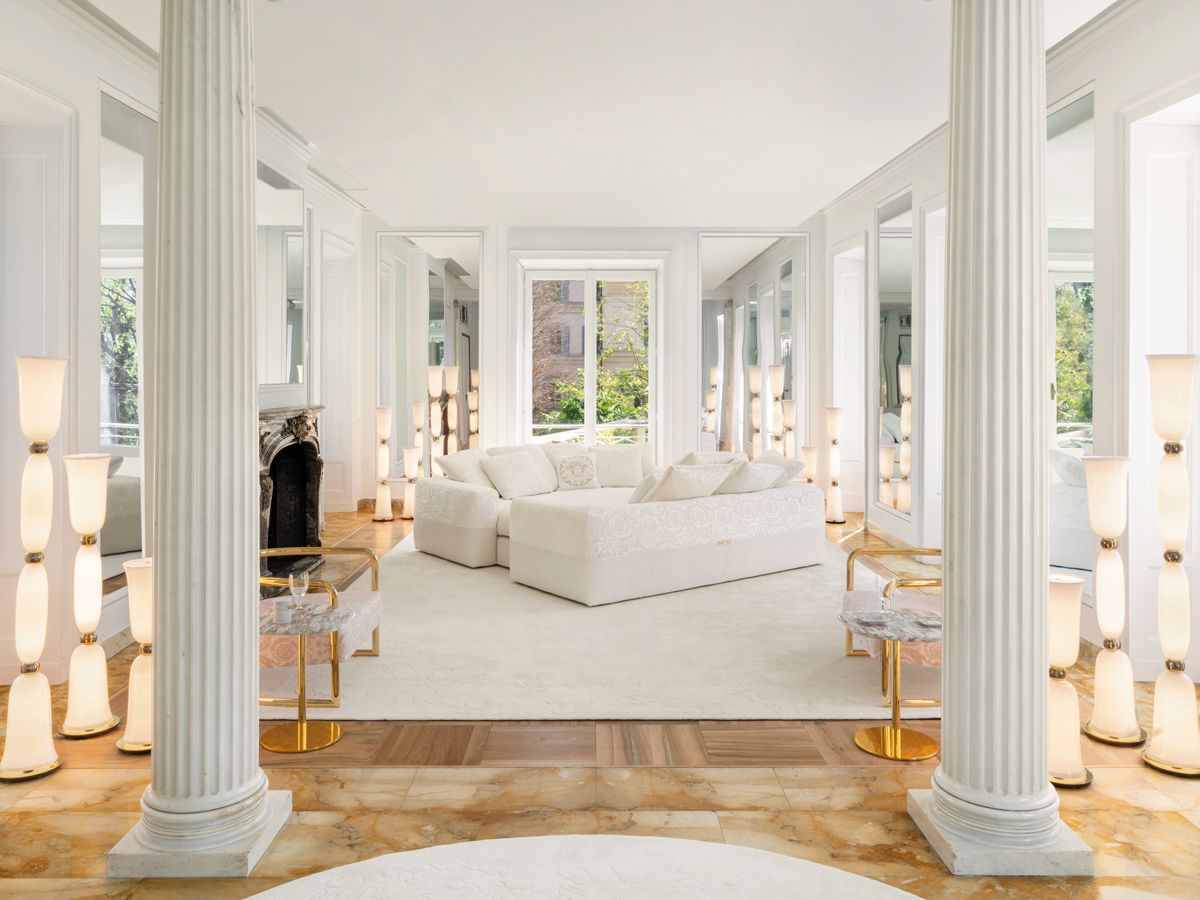 A living room dressed in white in the Versace Home showroom