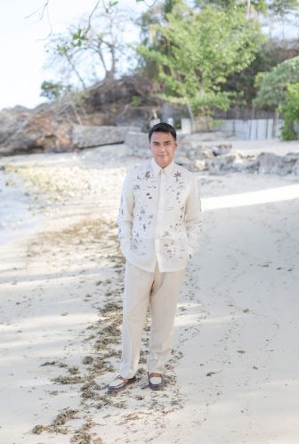 Groom Miggy Cruz poses for a photo.