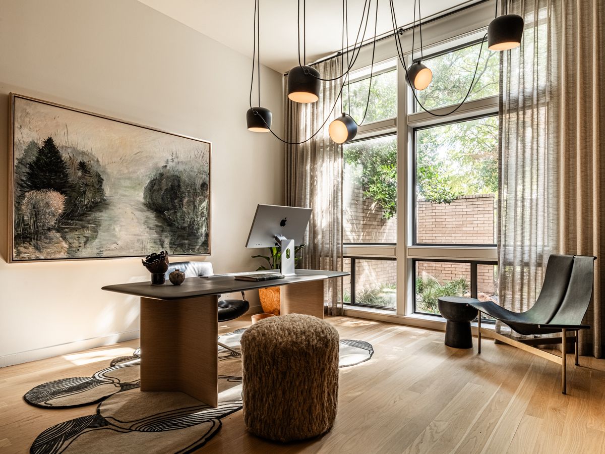 The ranch house's cosy office features a desk from Poltrona Frau, vintage FK84 swivel chair from Sputnik Modern, vintage TG-15 lounge chair, Pauline Esparon linen pouf, Aim lamps from Flos and a rug from Atelier Agahzadeh (Photo: Robert Tsai)