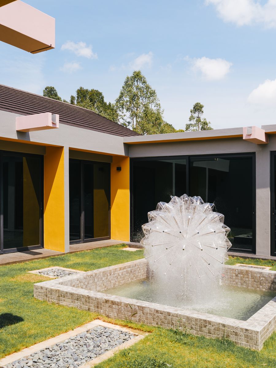 A sculptural fountain presides over the sun-kissed courtyard