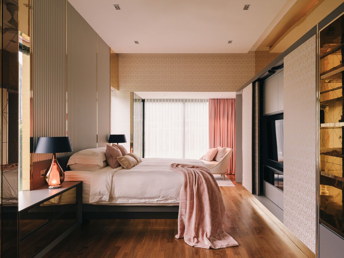 Pink and gold accents come together harmoniously to create a restful ambience in the master bedroom