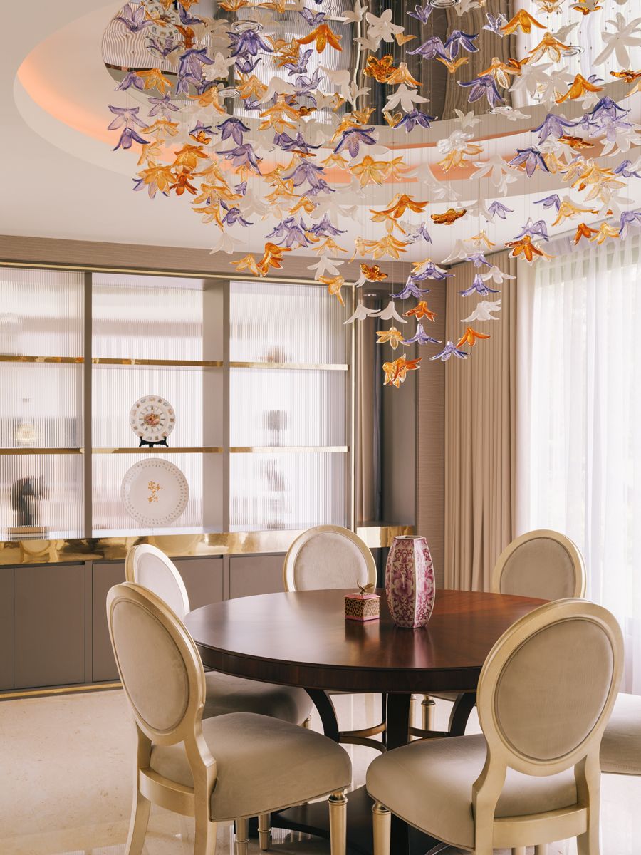 A glass-flower installation brings a romantic air to the dining area