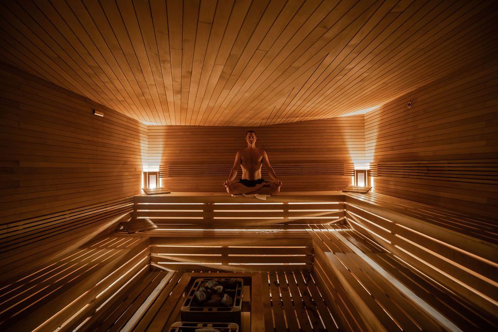 The dimly lit sauna invites guests to close their eyes and release any built-up tension