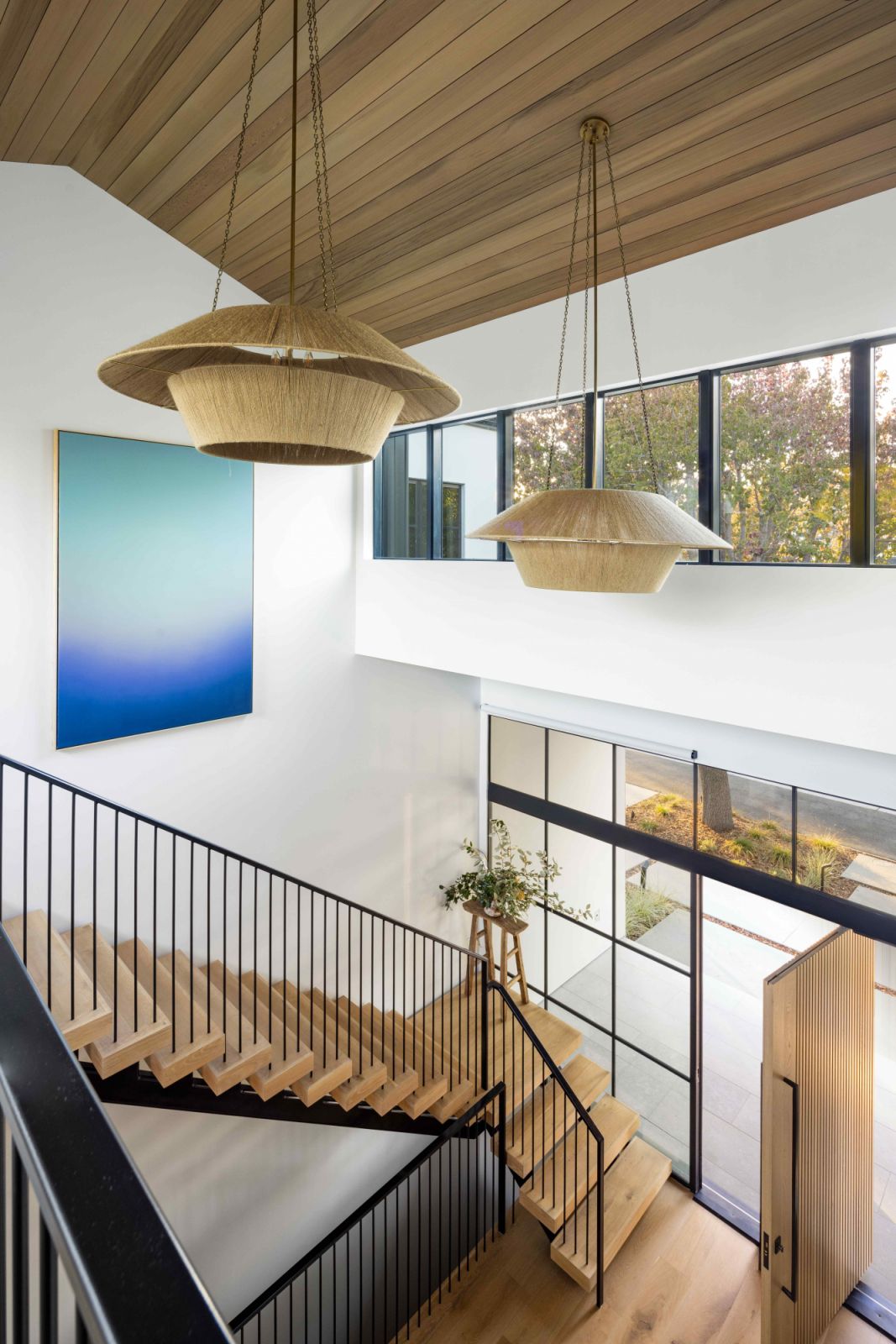 The vaulted two-storey entry hall with floor-to-ceiling glazing