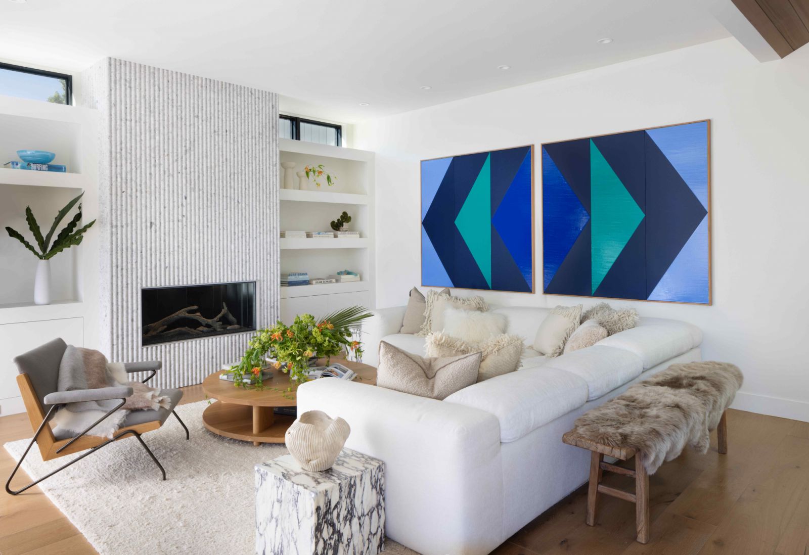 A ribbed stone fireplace adds character to the crisp living room