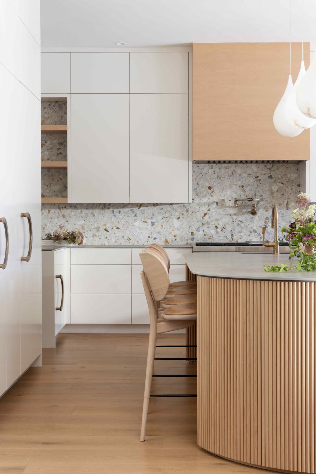 Gentle curves of the reeded, stained oval-shaped island counter