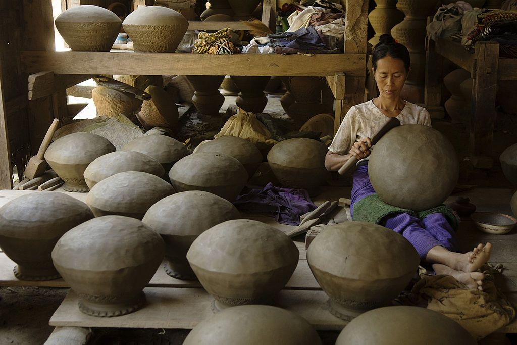 A woman shapes a terracotta pot in a village in Myanmar (Photo: Thierry Falise/LightRocket via Getty Images)