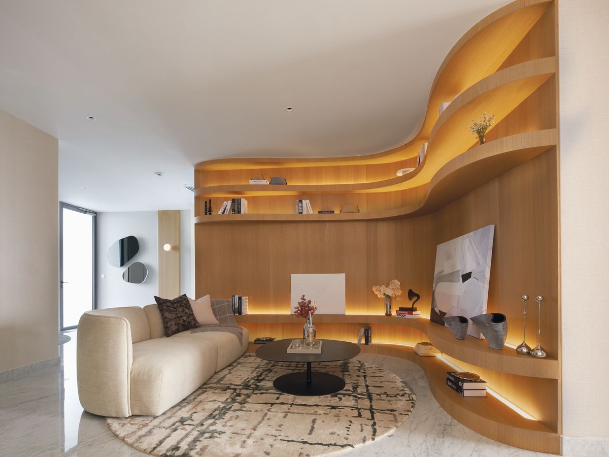The family room features display shelves with undulating curves that reference the movement of the waves (Photo: Benny Loh)