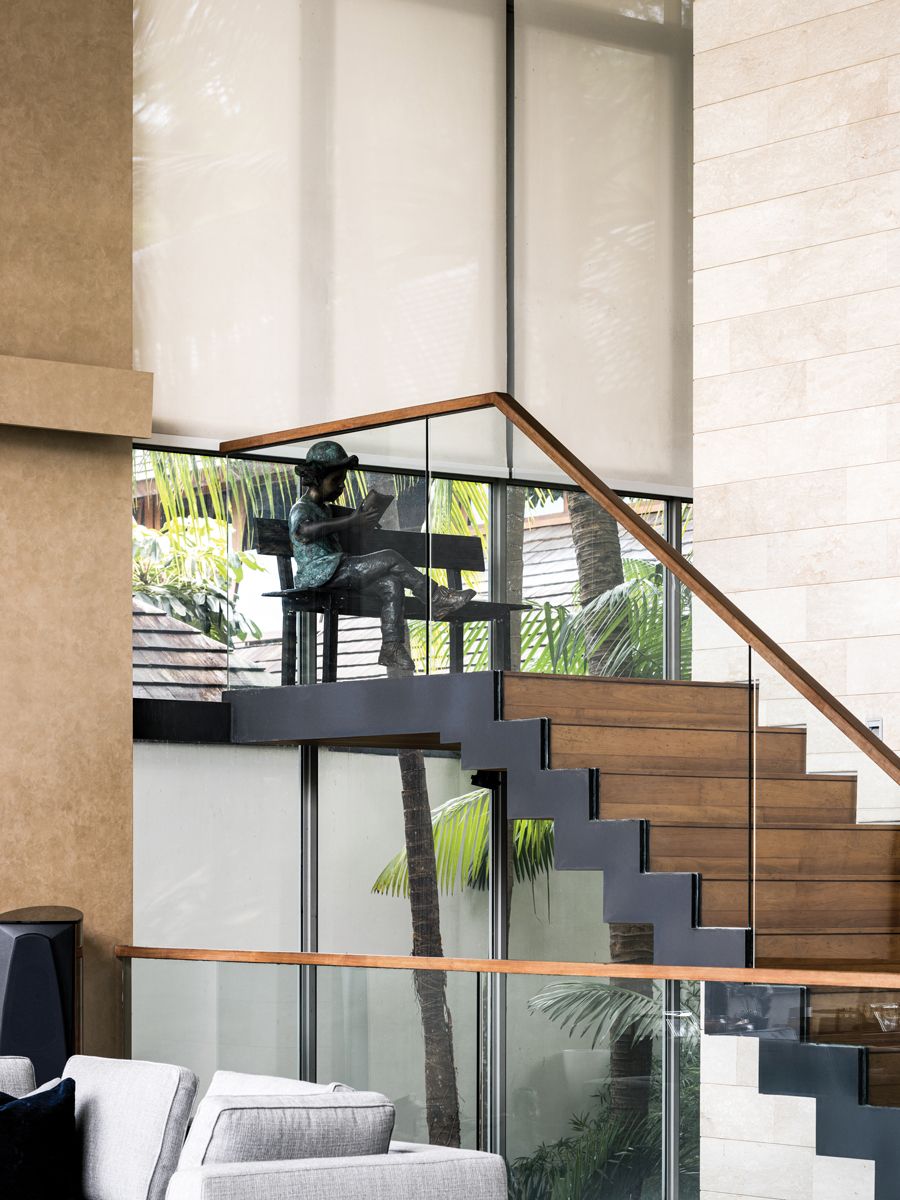 A sculpture of a reading child lends a charming touch to the stair landing (Photo: Designworx Interior Consultant)