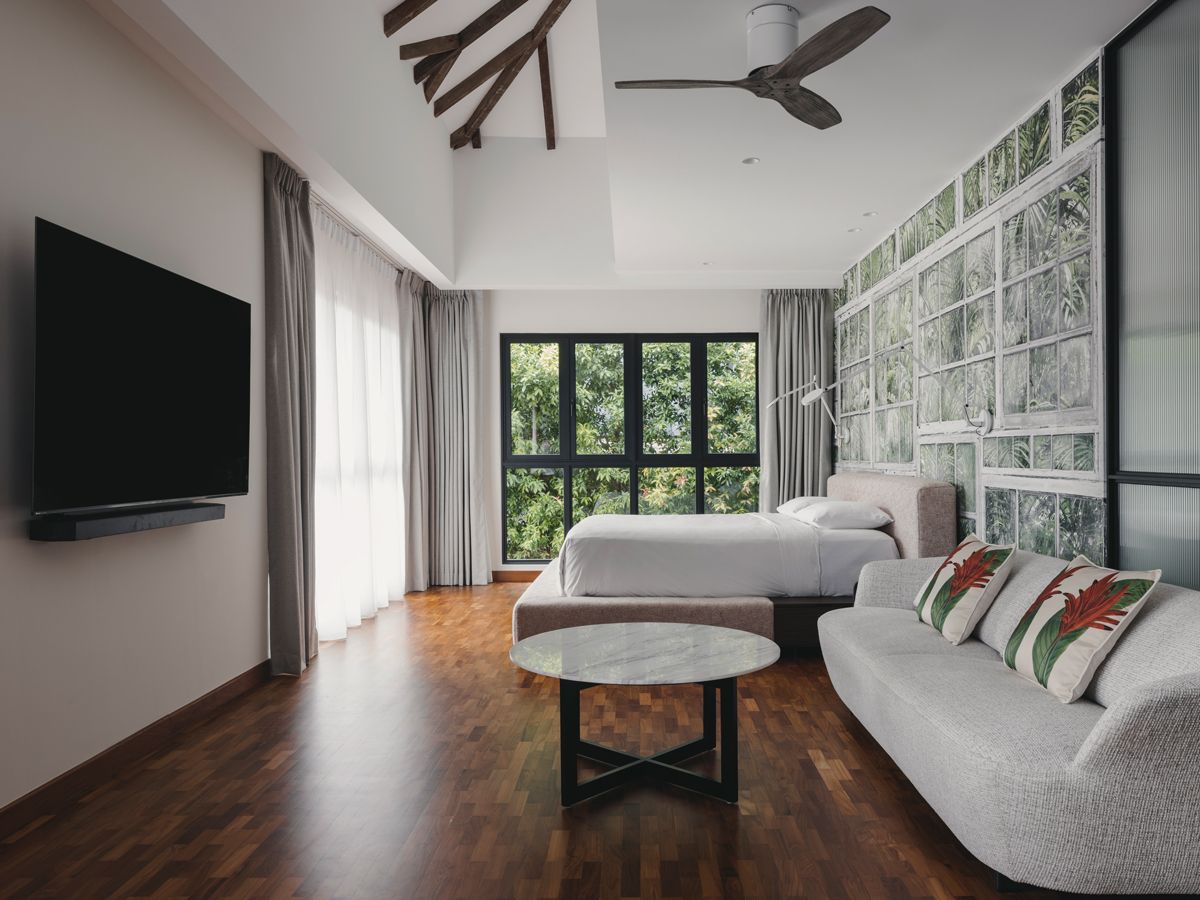 The master bedroom enjoys verdant views of foliage, echoed by the wallpaper design (Photo: Marc Tan / Studio Periphery)