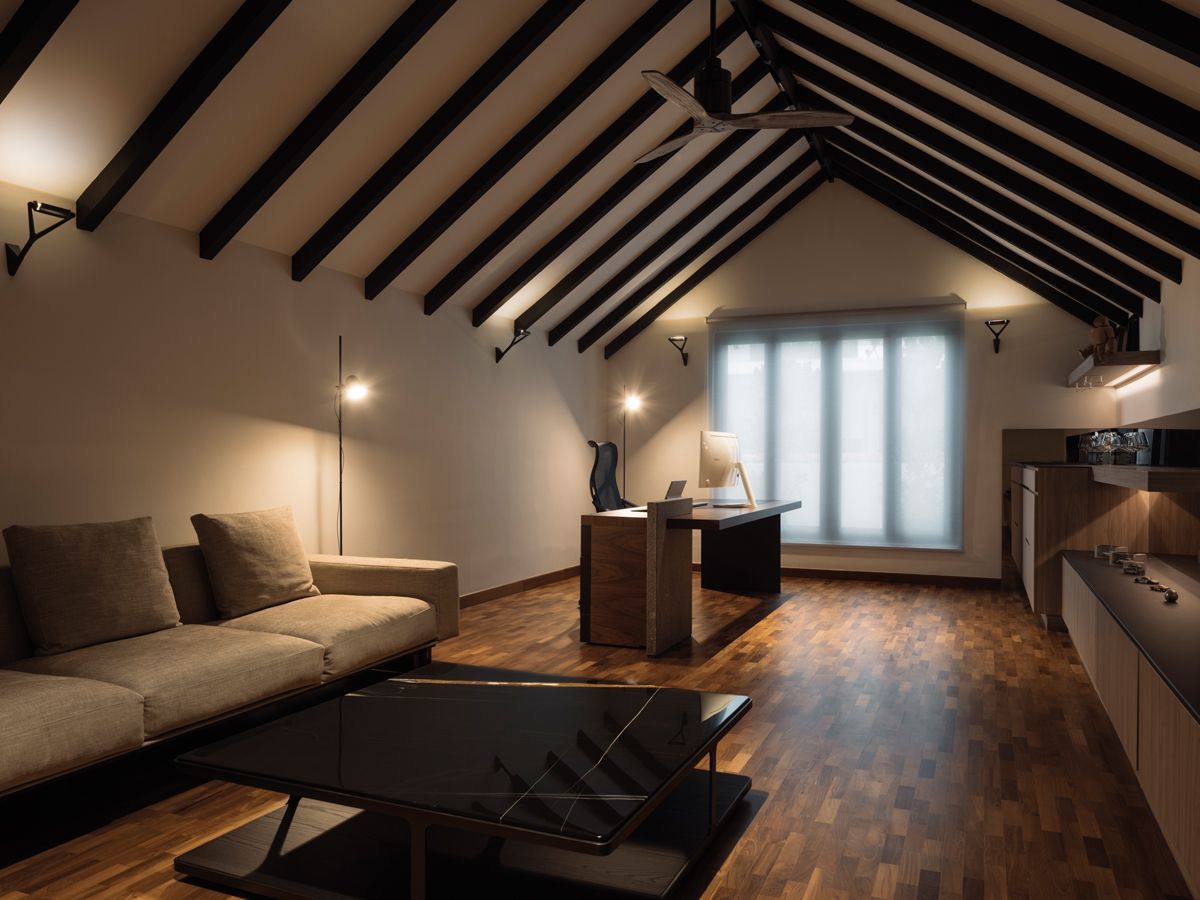 The serene study in the attic benefits from the lofty proportions of its pitched roof and the understated neutral scheme (Photo: Marc Tan / Studio Periphery)