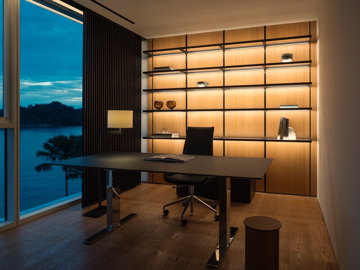 The study is illuminated with a shelving unit that emits a warm glow (Photo: Studio Periphery)