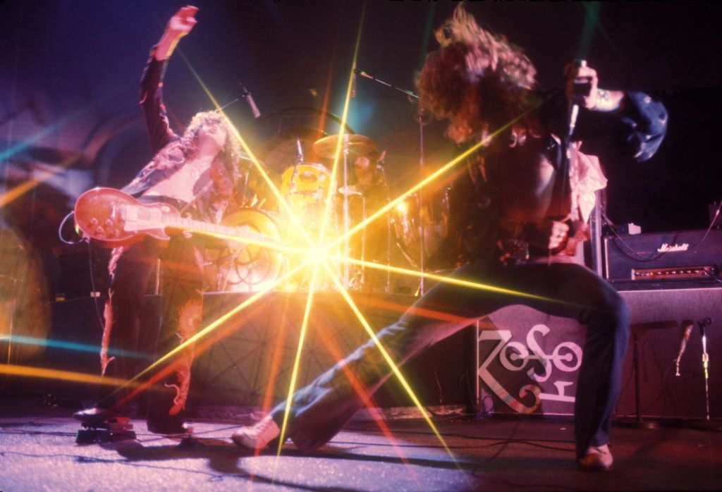 (MANDATORY CREDIT Watal Asanuma/Shinko Music/Getty Images) (L-R) Jimmy Page (guitar), John Bonham (drums), Robert Plant (vocals) of Led Zeppelin performing on stage with Marshall amplifiers behind, at Earl's Court, London, May 1975. (Photo by Watal Asanuma/Shinko Music/Getty Images)