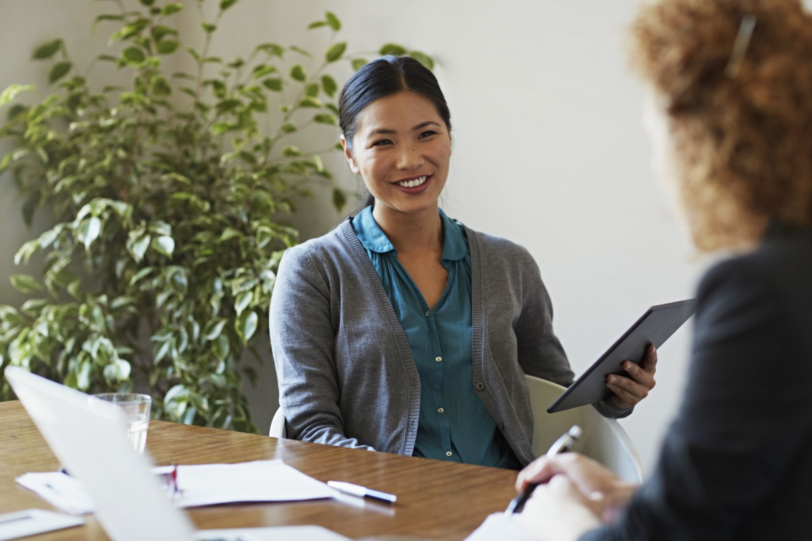 Business women discussing project at table in modern office